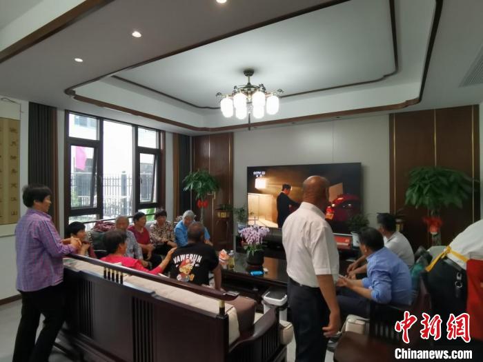 親友們集中在費(fèi)俊龍家中觀看返程的視頻。　鐘升 攝