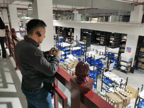 2023“一帶一路”媒體合作論壇聯(lián)合采訪團(tuán)團(tuán)員在仁和醫(yī)藥物流園拍攝記錄轉(zhuǎn)運流程。（本報記者 黃超攝）