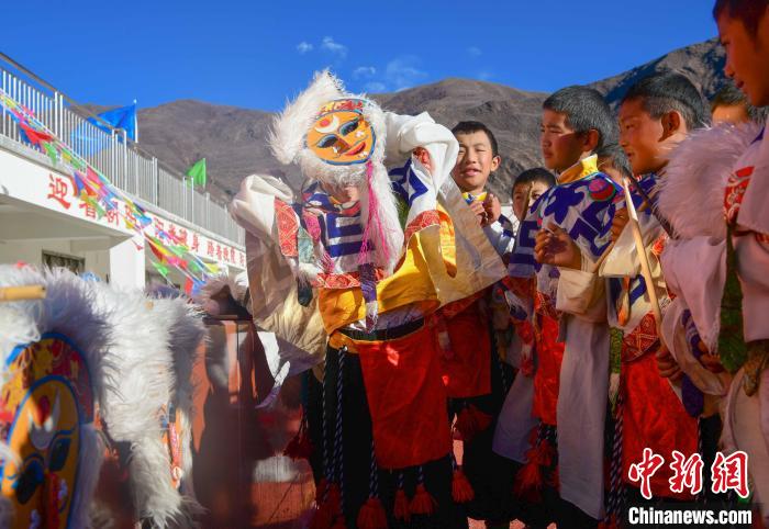 圖為加查縣安繞鎮(zhèn)小學學生在試穿藏戲面具。　貢嘎來松 攝