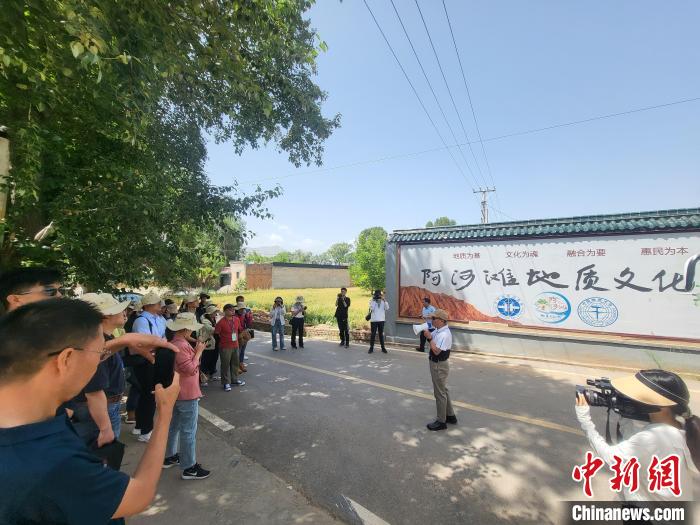 圖為中國(guó)地質(zhì)大學(xué)(北京)教授張緒教介紹村落情況?！『衍?攝