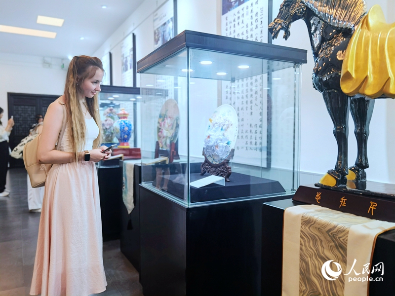 來(lái)自白俄羅斯的留學(xué)生喀秋莎駐足欣賞牡丹瓷。人民網(wǎng)記者 尚明楨攝