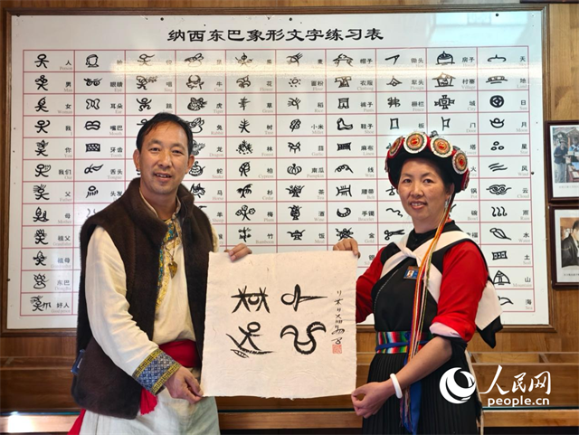 人民網(wǎng)“行進(jìn)中國”云南調(diào)研采訪團(tuán)走進(jìn)麗江，和閏元現(xiàn)場用東巴文寫下“行進(jìn)中國”。人民網(wǎng)記者 符皓攝