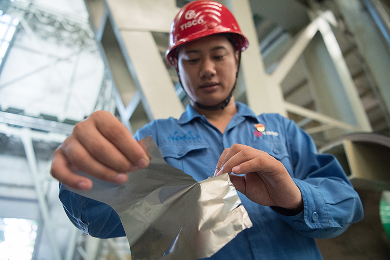 2018年8月8日，山西省太原市，太鋼精密帶鋼公司工作人員用手撕開不銹鋼。