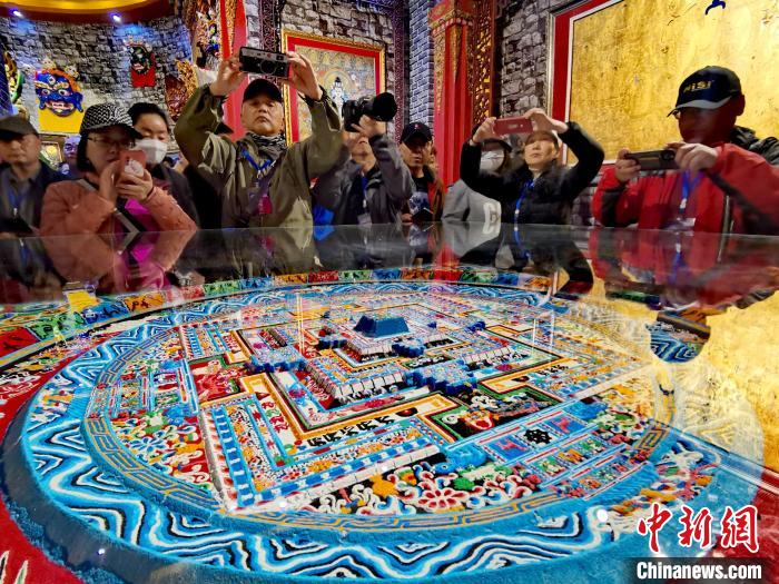 圖為參觀者拍攝壇城?！?zhí)砀?攝