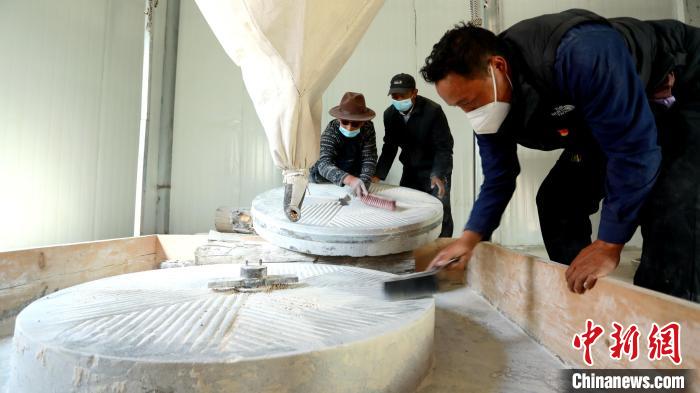 圖為合作社負(fù)責(zé)人完成糌粑加工后清掃水磨設(shè)施?！〖卫杩h融媒體中心供圖