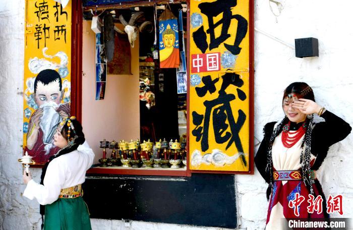 4月17日，游客身著藏式元素服裝在拉薩八廓街拍照留念?！±盍?攝