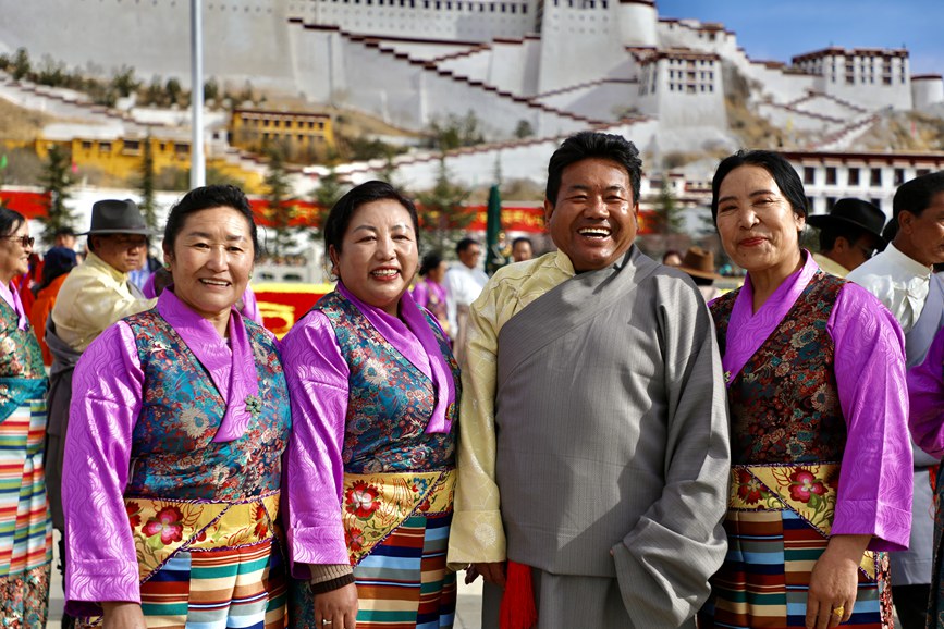 干部群眾身著盛裝在布達(dá)拉宮廣場(chǎng)留影。