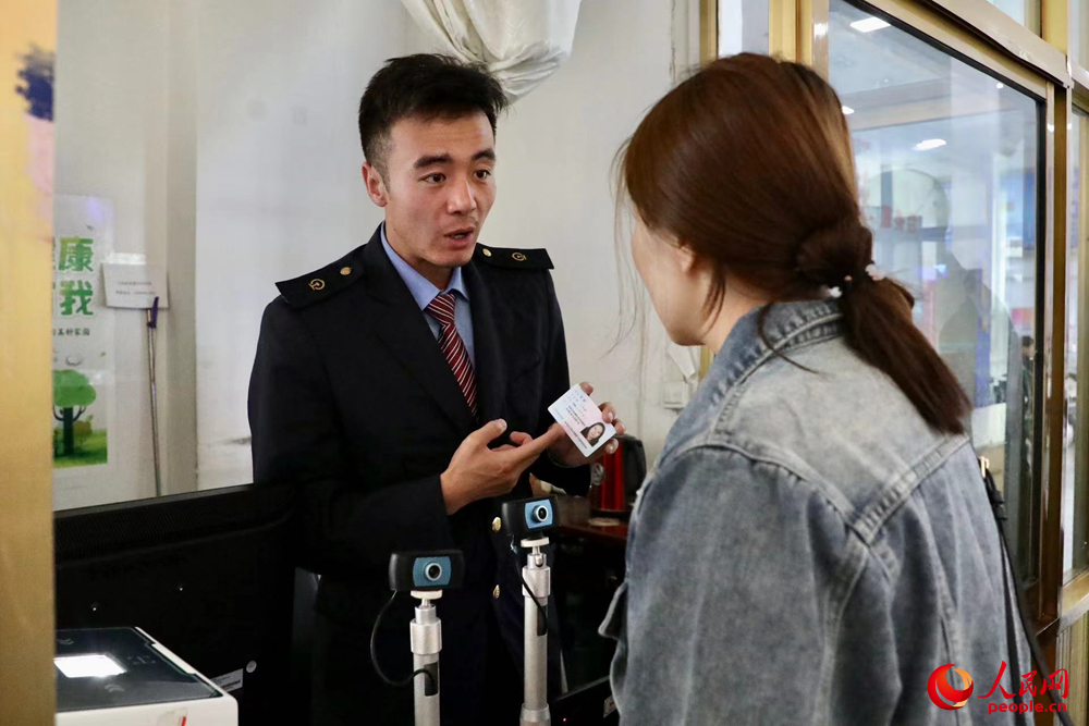 車站工作人員向旅客解答疑問(wèn)。人民網(wǎng)記者 次仁羅布攝