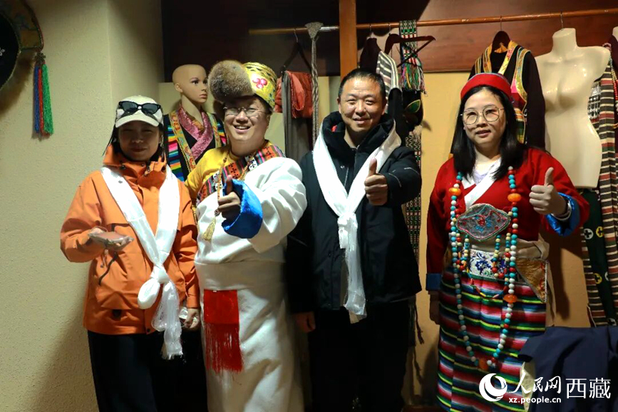 游客在扎西曲登社區(qū)體驗(yàn)藏族服飾文化。大家身著色彩鮮艷的藏裝，佩戴特色飾品，臉上洋溢著喜悅的笑容。人民網(wǎng)記者 吳雨仁攝